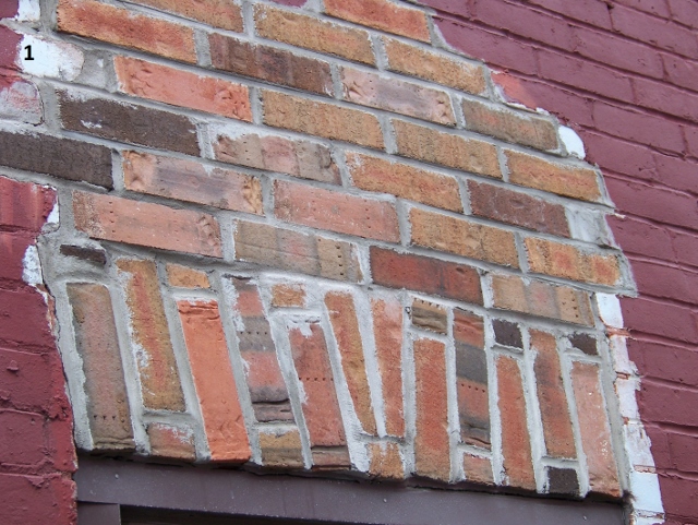 Picture 1 section of a brick wall that is different color than the rest