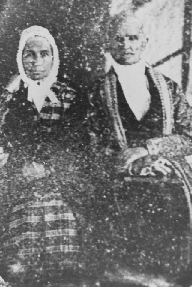 Olive and Jared Boughton very old black and white photo of couple sitting side by side in winter clo