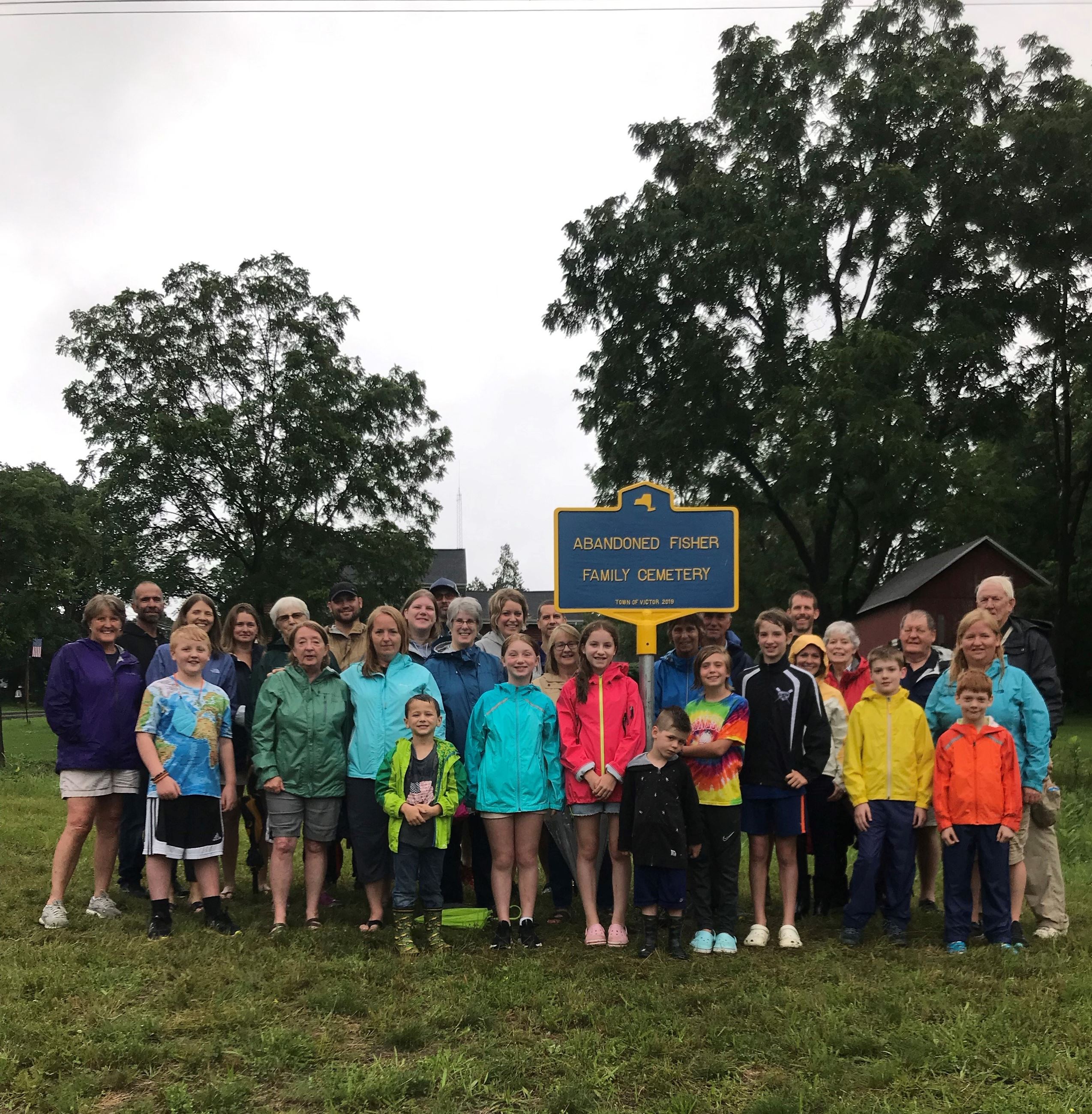 Fisher family all gathered around marker